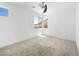 Empty bedroom with mountain views through two windows and a ceiling fan in a bright, modern space at 7222 Pulsar Mesa Ct, Las Vegas, NV 89148