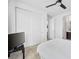 Modern bedroom with white bedding, ceiling fan and ensuite bathroom access with closet at 7222 Pulsar Mesa Ct, Las Vegas, NV 89148