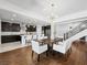 Open-concept dining area featuring a modern chandelier, seamlessly connecting to the kitchen and staircase at 7222 Pulsar Mesa Ct, Las Vegas, NV 89148