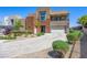 Contemporary two-story home with a balcony, three-car garage and desert landscaping at 7222 Pulsar Mesa Ct, Las Vegas, NV 89148