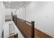 Upstairs hallway with wood floors and iron railing offers a view of the lower level at 7222 Pulsar Mesa Ct, Las Vegas, NV 89148