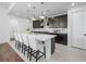 Bright kitchen with dark cabinetry, white countertops, stainless appliances, and an island with seating at 7222 Pulsar Mesa Ct, Las Vegas, NV 89148