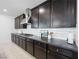 Close-up of kitchen with dark cabinets, stainless steel range hood, and white subway tile backsplash at 7222 Pulsar Mesa Ct, Las Vegas, NV 89148
