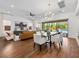 Open-concept home featuring wood floors, white walls, and a modern chandelier at 7222 Pulsar Mesa Ct, Las Vegas, NV 89148