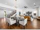 Open-concept home with dining area, wood floors, and staircase to the second floor at 7222 Pulsar Mesa Ct, Las Vegas, NV 89148