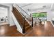 Open-concept home featuring wood floors, an iron-railed staircase, and dining area at 7222 Pulsar Mesa Ct, Las Vegas, NV 89148