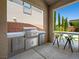 Outdoor kitchen with a built-in grill, bar seating, and direct access to the backyard, perfect for entertaining at 7222 Pulsar Mesa Ct, Las Vegas, NV 89148