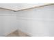Empty walk-in closet with neutral carpeting and a single high closet rod for hanging clothing at 7222 Pulsar Mesa Ct, Las Vegas, NV 89148