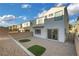 A low maintenance backyard featuring desertscape and small grass patches for visual contrast at 8043 Tank Loop St, Las Vegas, NV 89166