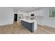Modern kitchen with an island bar, stainless steel appliances, and bright white cabinets at 8043 Tank Loop St, Las Vegas, NV 89166