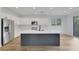 Modern kitchen featuring a large island, stainless steel appliances, and white cabinetry at 8043 Tank Loop St, Las Vegas, NV 89166