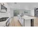 Bright kitchen showcasing quartz countertops, stainless steel appliances, and an island with a sink at 8043 Tank Loop St, Las Vegas, NV 89166