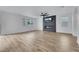 Spacious living area with a fireplace, large windows, and wood-look floors at 8043 Tank Loop St, Las Vegas, NV 89166