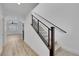 Staircase featuring modern metal railings and wood accents leading to the upper level at 8043 Tank Loop St, Las Vegas, NV 89166