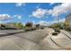 A street view featuring an entrance to a community and landscaping at 8043 Tank Loop St, Las Vegas, NV 89166