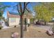 A charming backyard with a tiled roof home, stone, gravel, seating area, and solar panels at 8217 Ashkum Ave, Las Vegas, NV 89149