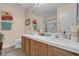 Bathroom featuring double vanity with mirrors, tile flooring, and a glass shower at 8217 Ashkum Ave, Las Vegas, NV 89149