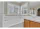 Bathroom featuring a soaking tub and double vanity at 8217 Ashkum Ave, Las Vegas, NV 89149
