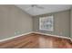 Bright bedroom featuring vaulted ceilings, hardwood floors, and shuttered windows at 8217 Ashkum Ave, Las Vegas, NV 89149