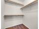 A simple closet with brown wood floor and shelving unit, ideal for home organization at 8217 Ashkum Ave, Las Vegas, NV 89149
