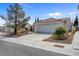 Charming single-story home with a two-car garage, tile roof, desert landscaping and ample parking space at 8217 Ashkum Ave, Las Vegas, NV 89149