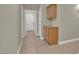 Hallway with built-in storage and tile flooring, leading to the laundry area at 8217 Ashkum Ave, Las Vegas, NV 89149