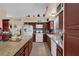 Spacious kitchen featuring granite countertops, white appliances and dark wood cabinetry at 8217 Ashkum Ave, Las Vegas, NV 89149