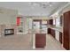 Spacious kitchen featuring dark wood cabinets, white appliances, and an island with granite countertops at 8217 Ashkum Ave, Las Vegas, NV 89149