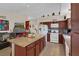 Open concept kitchen features granite countertops, central island and stainless steel appliances at 8217 Ashkum Ave, Las Vegas, NV 89149