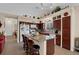 Bright kitchen featuring granite countertops, dark wood cabinetry, and a central island at 8217 Ashkum Ave, Las Vegas, NV 89149