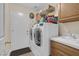 Laundry room featuring a sink, two washing machines, and a storage shelf at 8217 Ashkum Ave, Las Vegas, NV 89149