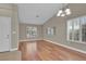 Bright living room boasts hardwood floors, vaulted ceilings, shuttered windows, and stylish light fixture at 8217 Ashkum Ave, Las Vegas, NV 89149
