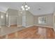 Spacious living room with hardwood floors, neutral walls, vaulted ceilings, and a modern light fixture at 8217 Ashkum Ave, Las Vegas, NV 89149