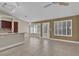 Open-concept living room featuring tile floors, lots of windows, neutral paint colors, and bar seating at 8217 Ashkum Ave, Las Vegas, NV 89149