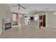 Open concept living room, connected to the kitchen, with a cozy fireplace and tile flooring throughout at 8217 Ashkum Ave, Las Vegas, NV 89149
