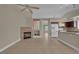 Bright living room with tile floors, a fireplace, and seamless flow into an updated kitchen, perfect for entertaining at 8217 Ashkum Ave, Las Vegas, NV 89149