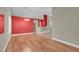 Open-concept living room showcasing hardwood floors, neutral paint, archways, and modern fixtures at 8217 Ashkum Ave, Las Vegas, NV 89149