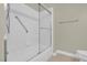 Bright bathroom showcasing shower with sliding glass doors, white tiled walls and silver hardware at 8217 Ashkum Ave, Las Vegas, NV 89149
