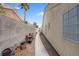 Side yard featuring a walkway, rock landscaping and storage for outdoor equipment at 8217 Ashkum Ave, Las Vegas, NV 89149
