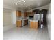 Bright kitchen features tile floors, wood cabinets, island, and track lighting at 8419 W Rochelle Ave, Las Vegas, NV 89147