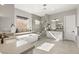 Bright bathroom featuring a soaking tub, glass-enclosed shower, and double vanities with modern fixtures at 8575 Nicholas James Ave, Las Vegas, NV 89143