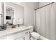 Well-lit bathroom featuring modern fixtures, including a vanity with counter space and a shower with curtain at 8575 Nicholas James Ave, Las Vegas, NV 89143