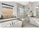 Bathroom view featuring a soaking tub, glass shower, and decorative accents for a luxurious experience at 8575 Nicholas James Ave, Las Vegas, NV 89143
