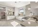 Modern bathroom featuring a soaking tub, glass shower, double vanities and large mirror above the sink at 8575 Nicholas James Ave, Las Vegas, NV 89143