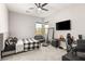 Bright bedroom features a ceiling fan, a comfortable bed, and a designated desk space at 8575 Nicholas James Ave, Las Vegas, NV 89143