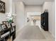 Bright foyer featuring neutral tones and views of the open concept living area and backyard at 8575 Nicholas James Ave, Las Vegas, NV 89143