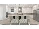 Spacious kitchen featuring white cabinetry, stainless steel appliances, pendant lighting, and a large center island with seating at 8575 Nicholas James Ave, Las Vegas, NV 89143
