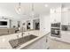 Modern kitchen with large island and sink, stainless steel appliances, and an open layout connected to the living spaces at 8575 Nicholas James Ave, Las Vegas, NV 89143