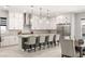 Gourmet kitchen with stainless steel appliances, white cabinetry, and a large center island with seating at 8575 Nicholas James Ave, Las Vegas, NV 89143