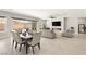 Open floor plan features a modern fireplace, comfortable seating, and backyard access at 8575 Nicholas James Ave, Las Vegas, NV 89143